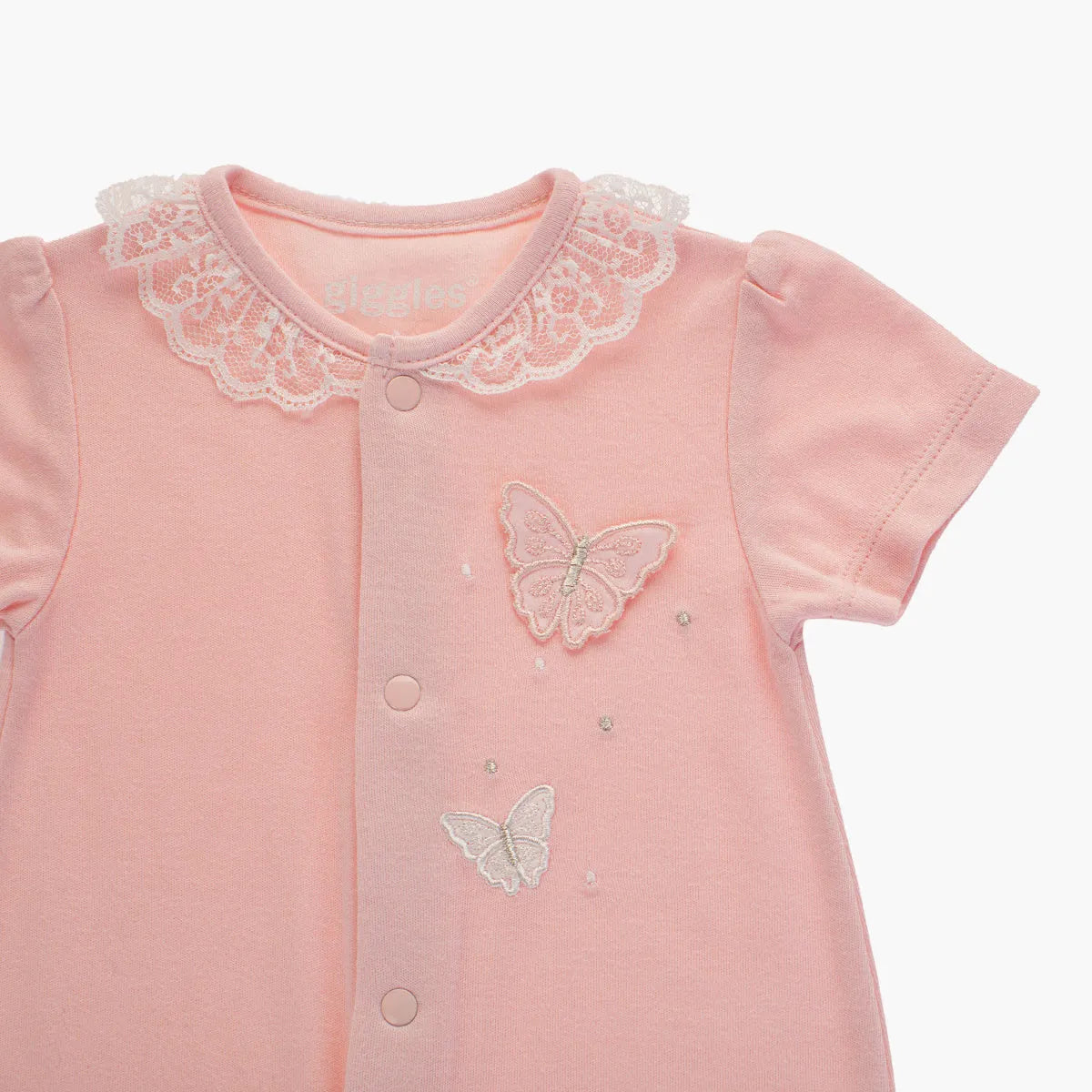 Pink baby romper close-up: lace collar and embroidered butterfly details