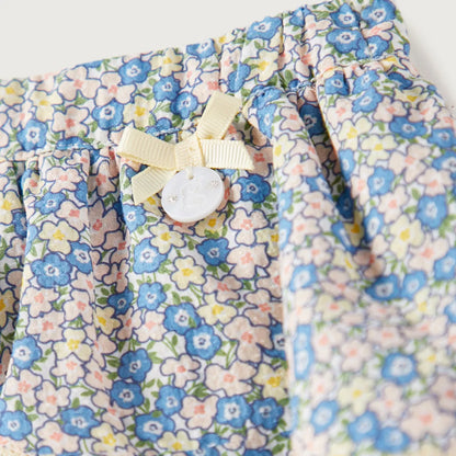 Cream floral skirt with double ruffle, bow button detail, elastic waistband