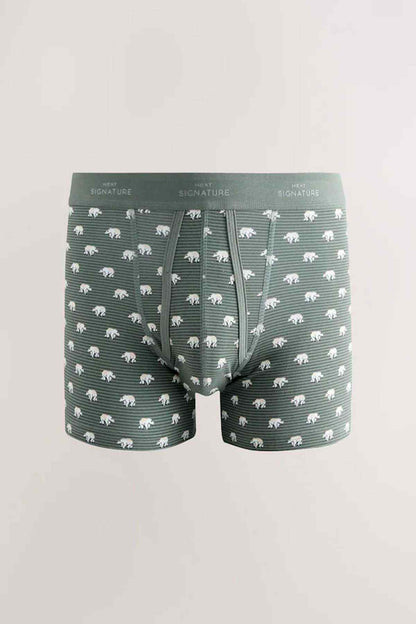 Green boxer shorts with repeating animal print and elastic waistband