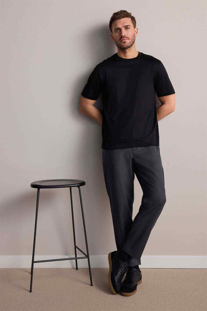 Next black crew-neck short-sleeve T-shirt on model, full body side view