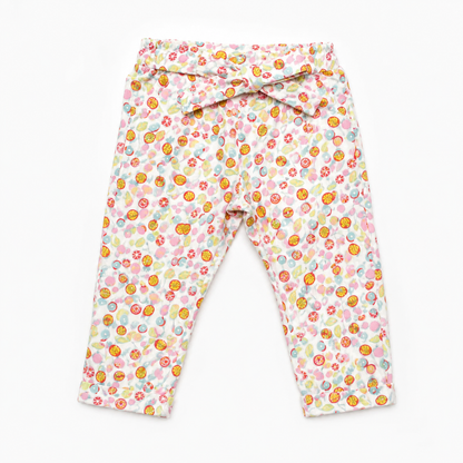 BABYSHOP baby pants, white fabric with colorful fruit print, elastic waist, flat lay
