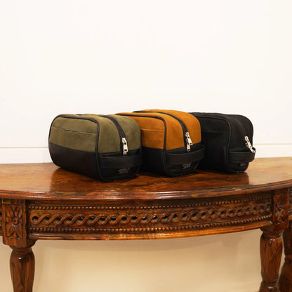 Set of three two-tone toiletry bags in olive, orange, and black