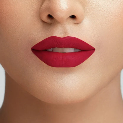 Conatural velvet lipstick on lips, bold ruby-red matte color