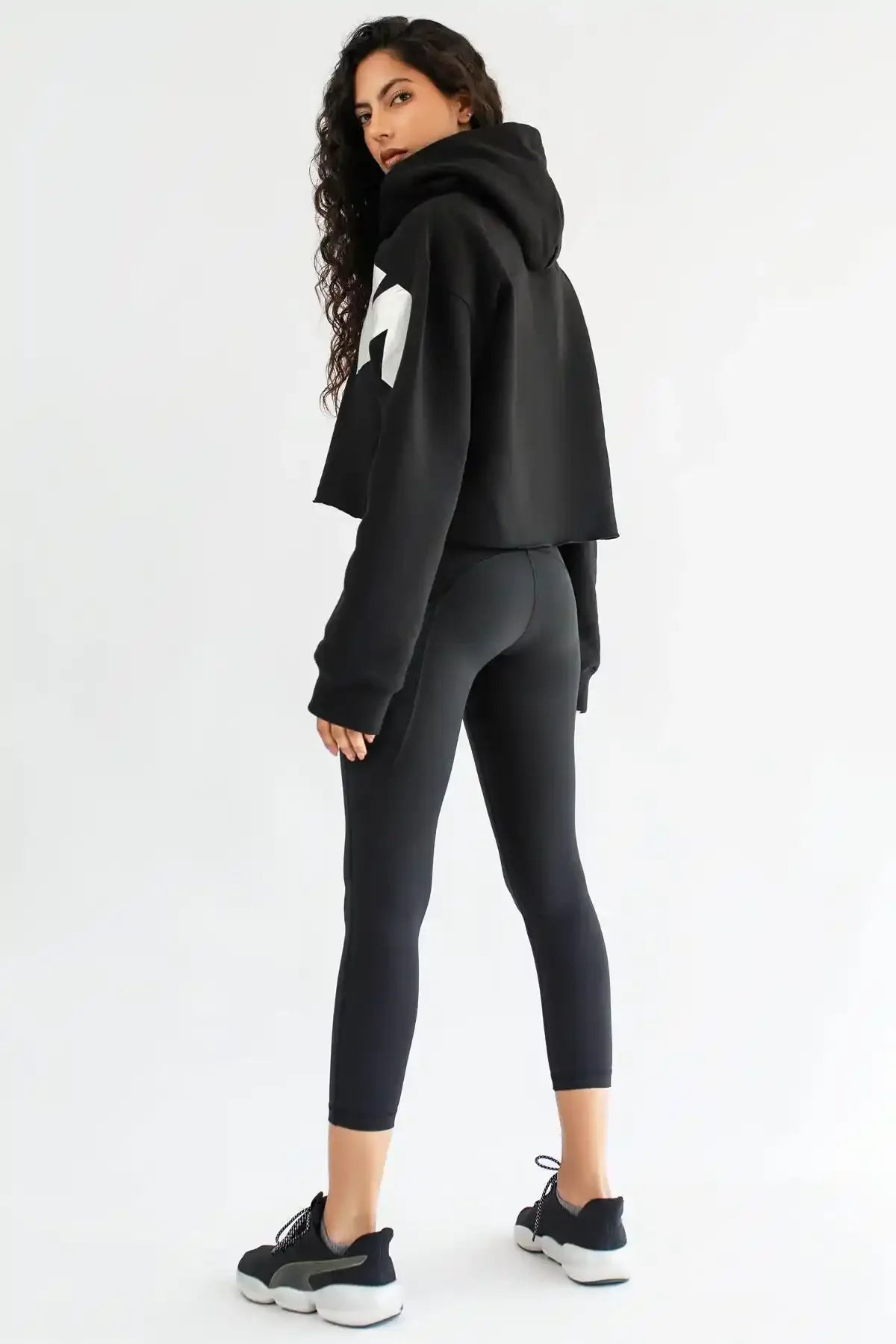 Black cropped leggings with white side logo and sleek tapered leg