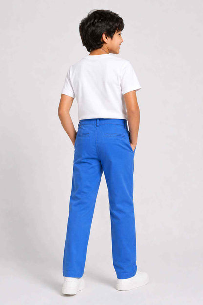 Blue denim pants for kids back view with button waist and straight legs.