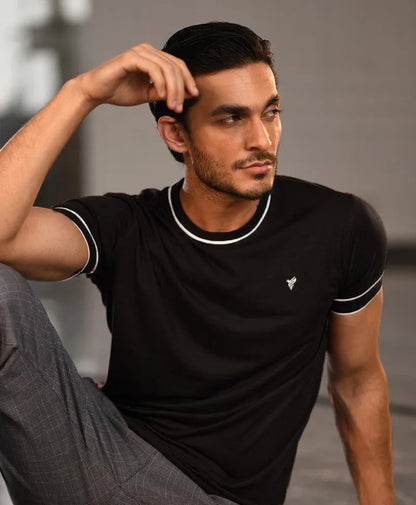 Men's fitted black t-shirt with white-trim crew neck and sleeve cuffs, chest logo