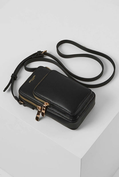 Black crossbody bag with flap front and zipper, gold hardware, long shoulder strap