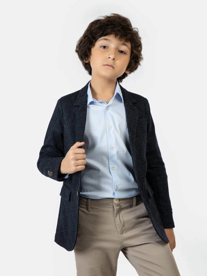 Blue boys blazer with notch lapels and flap pockets over light blue shirt