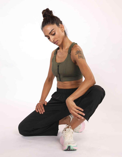 Olive green sports bra with front zipper and strappy back