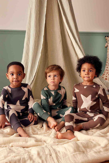 Kids star-print pajama sets on children: dark, dark green, and brown with ecru stars