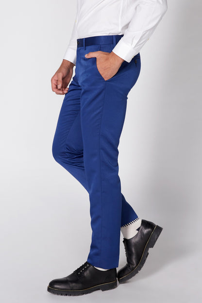 Men's blue suit trousers and blazer in side profile, black oxford-style shoes