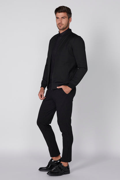Black zip-front jacket with stand collar, shown in side view