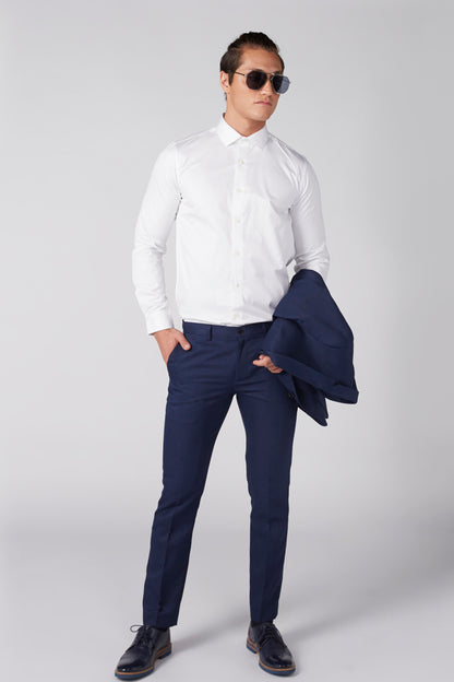 White button-up dress shirt with long sleeves and button front, worn with dark pants