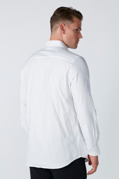 White button-up dress shirt back view with long sleeves and curved hem