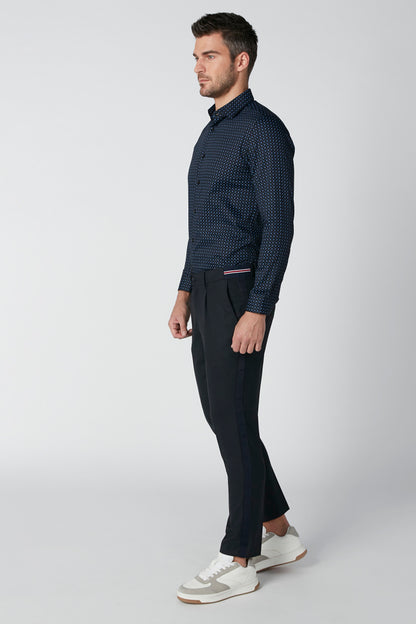 Navy patterned dress shirt and black slim trousers, belt loops