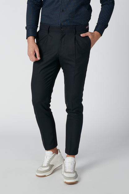 Black tapered trousers with side pockets and cuffed hem