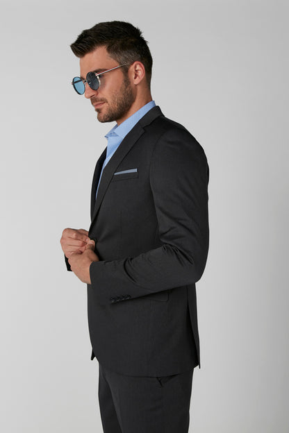 Men's dark suit jacket with notch lapels and chest pocket, side view on model