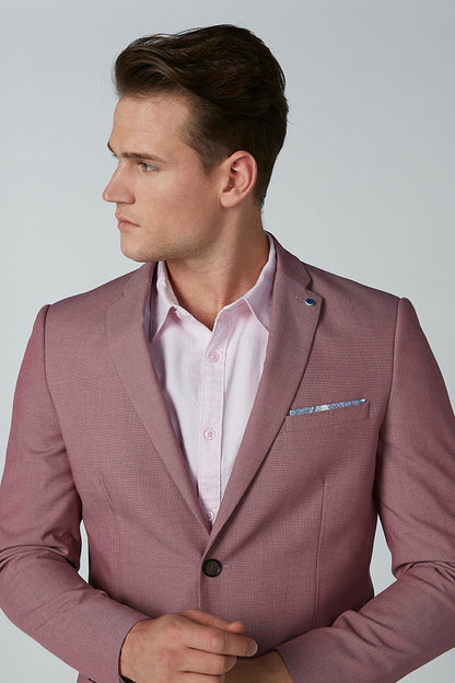 Men's pink suit jacket close-up with lapel, pocket square, and white dress shirt