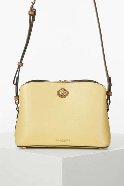 Yellow leather shoulder bag with gold logo clasp and adjustable strap
