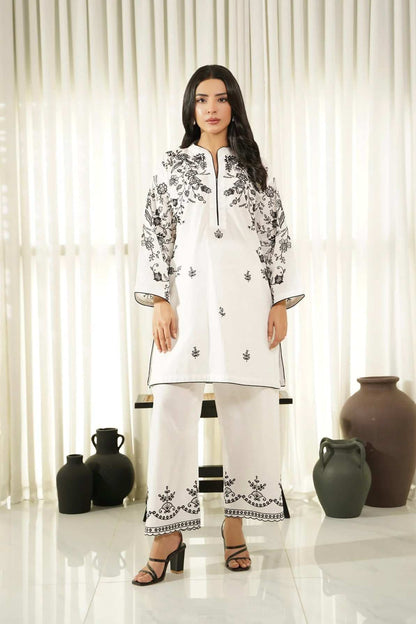 White embroidered tunic with black floral print, front buttons and side ties