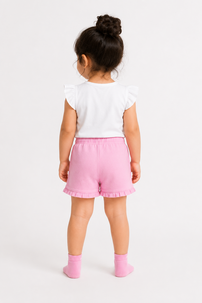 Pink baby shorts with drawstring and ruffle trim, paired with pink socks