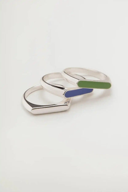 Silver-tone enamel inlay rings, overlapping close-up with blue and green