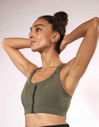 Olive green high-neck sports bra with front zipper and cross-back