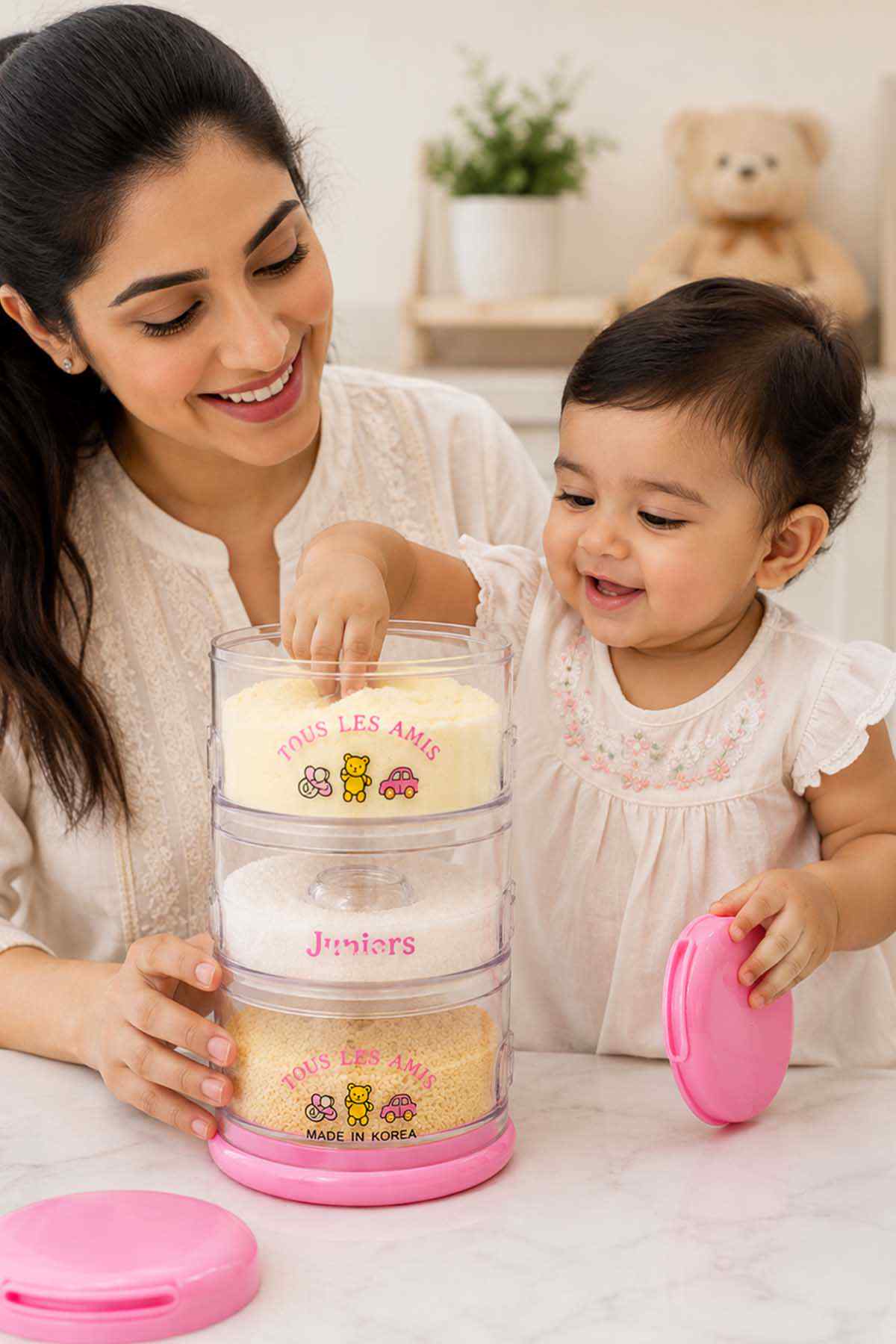 Pink clear kids snack container with pink lid and stacked compartments