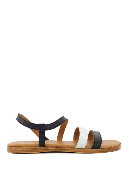 Black and white flat sandals with double ankle straps and tan rubber sole