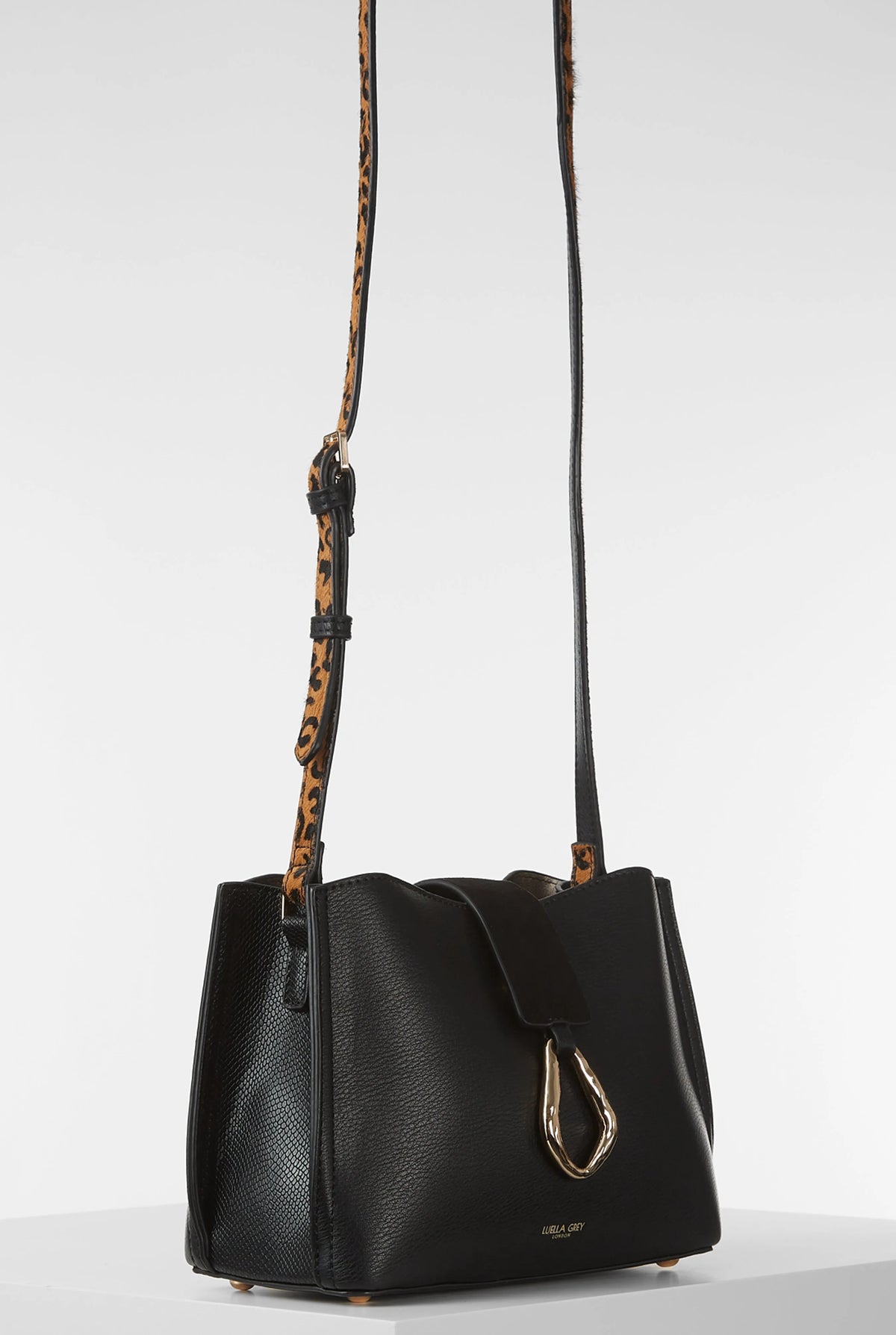 Black leather-look small shoulder bag with front clasp and patterned crossbody straps