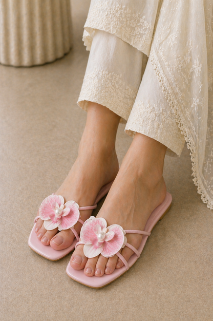 Light pink slide sandals with two flower appliques and pearl center on toe straps