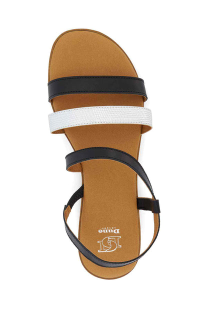 Black and white two-strap flat sandals with ankle strap and tan footbed