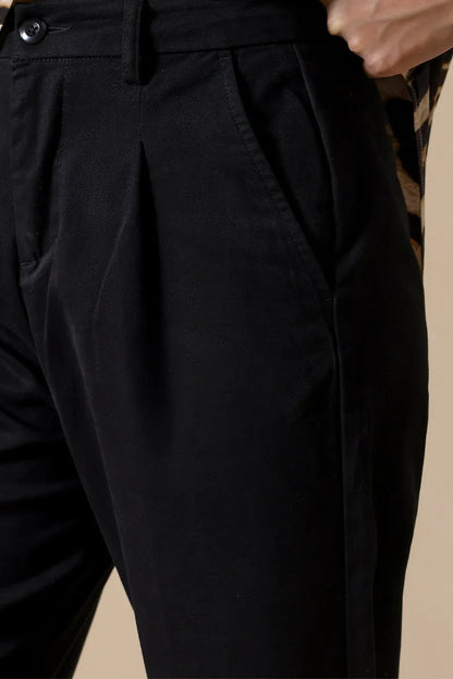 Black pants with pleated front, button waistband, and straight wide legs