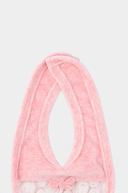 Pink baby bib close-up with rounded neck opening and inner bow detail