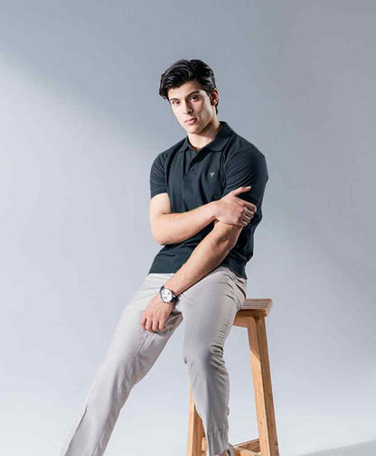 Dark fitted polo shirt with spread collar, short sleeves, and embroidered chest logo
