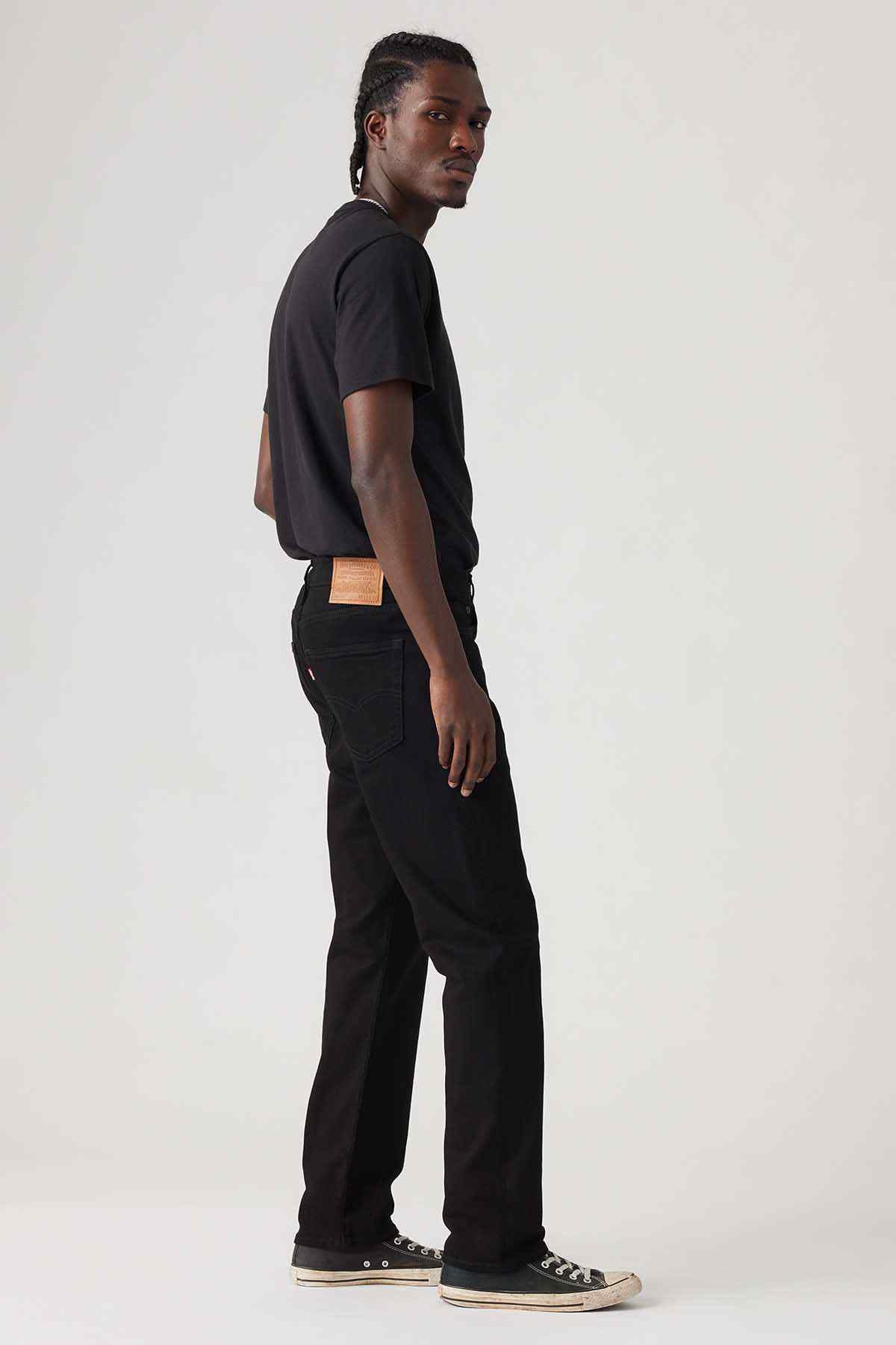 Black denim jeans in straight fit, side view with belt loops and pockets