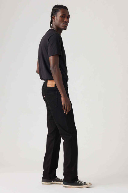 Black denim jeans in straight fit, side view with belt loops and pockets