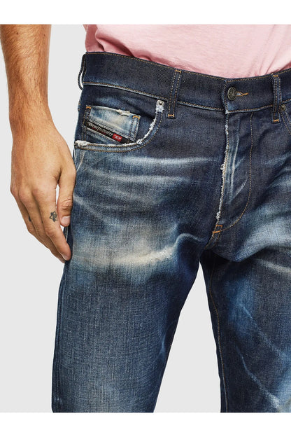 Dark blue denim jeans close-up of front pocket and waistband, button fly