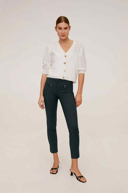 White textured button-front cardigan and dark green ankle-length slim pants