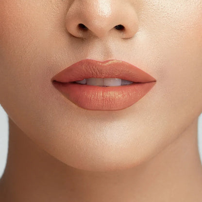 Close-up of lips wearing rose nude lipstick finish.