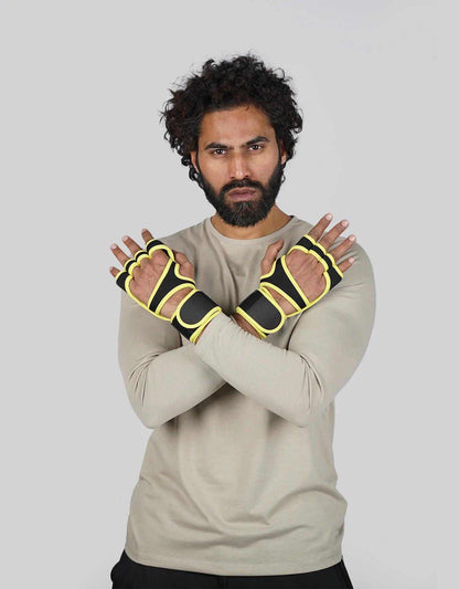 Bodybrics fingerless weightlifting gloves in black with yellow trim, worn arms crossed.
