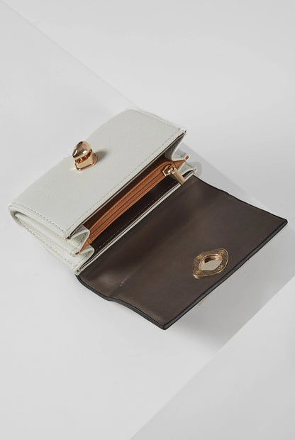 Two-tone brown and white leather wallet with gold snap clasp, open front