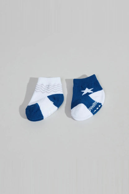 Pair of baby socks: one white with blue trim and plane print, one dark blue.