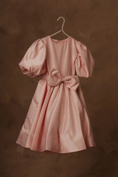 Pink puff-sleeve dress with gathered waist bow and skirt flare, on pearl hanger.
