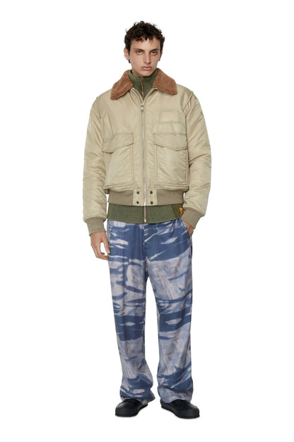 Cream bomber jacket with brown sherpa collar, zip front, and ribbed cuffs.