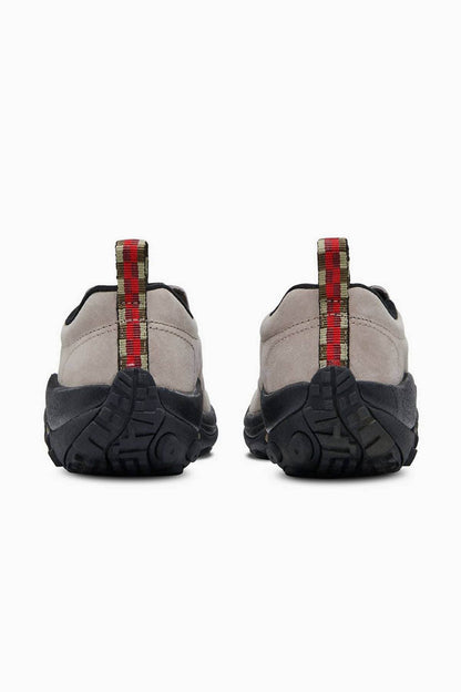 Taupe slip-on shoes with rear plaid strap and black textured rubber sole