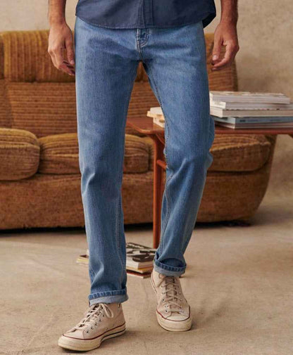 Fitted light-wash denim jeans showing cuffed hems and tapered leg seams