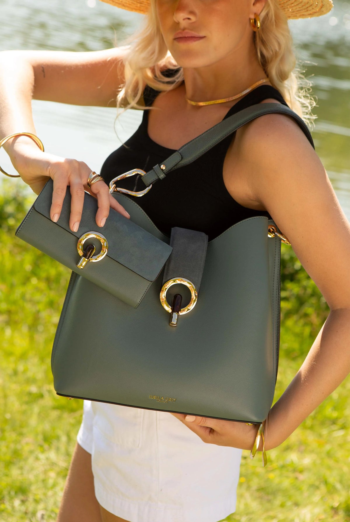 Green bag with front flap, gold-ring clasp, and chain shoulder strap