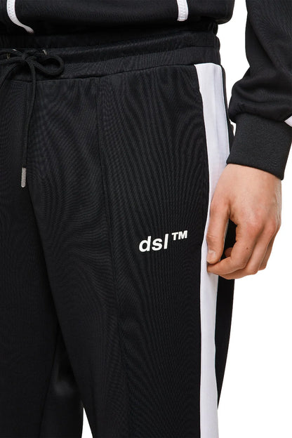 Black textured jogger pants close-up with drawstring and ds1TM logo on leg