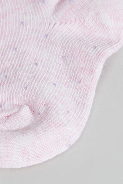 Close-up of pink baby sock knit with ribbed cuff and heel